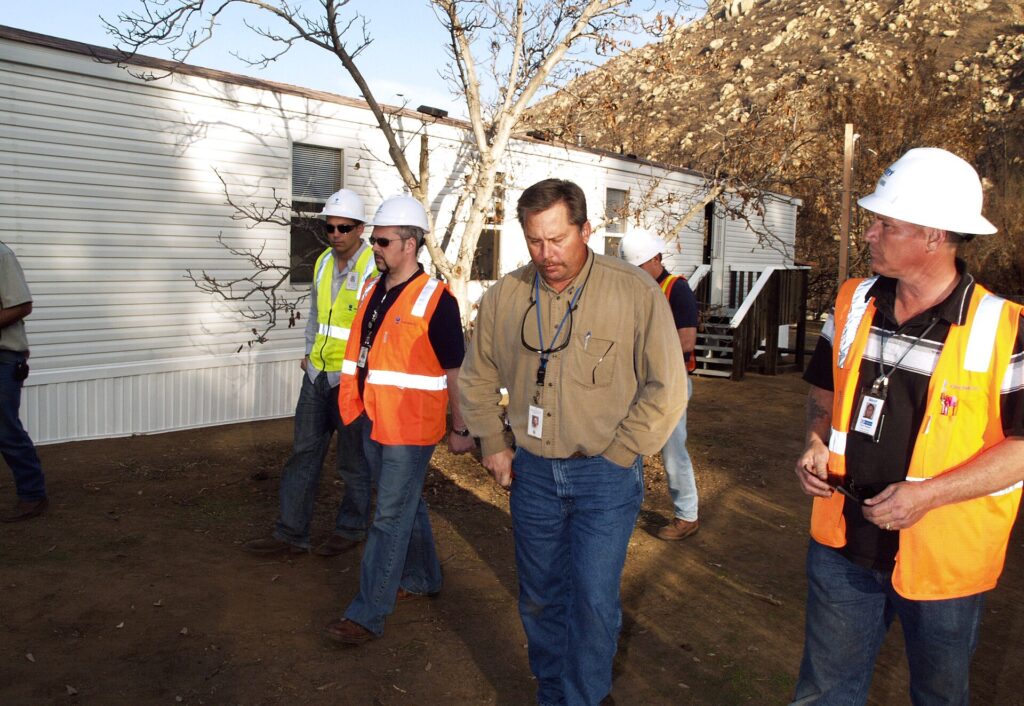 Building inspector talking with contractors during a code inspection