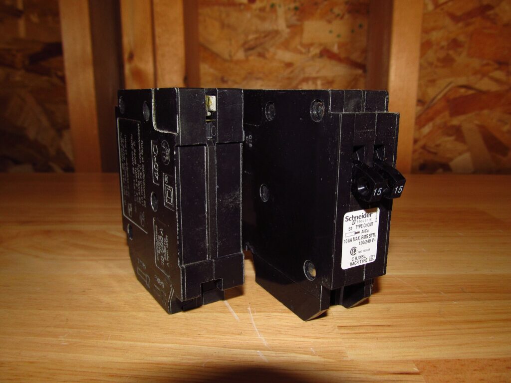 Residential 15 amp circuit breaker shown from the front and back